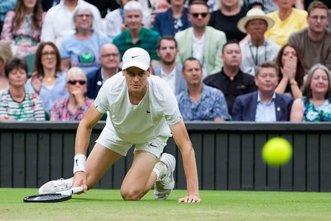 Jannik Sinner falls during his match against Daniil Medvedev